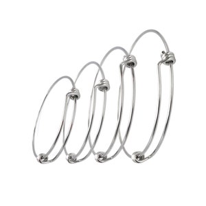 May include: Four silver bangle bracelets of different sizes, each with a twisted wire closure.
