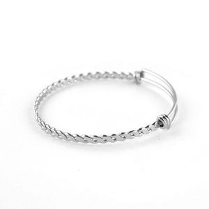 May include: A silver braided bangle bracelet with a spring clasp.