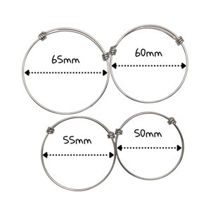 May include: Three silver bangle bracelets with different diameters. The bracelets are 65mm, 60mm, and 55mm in diameter.