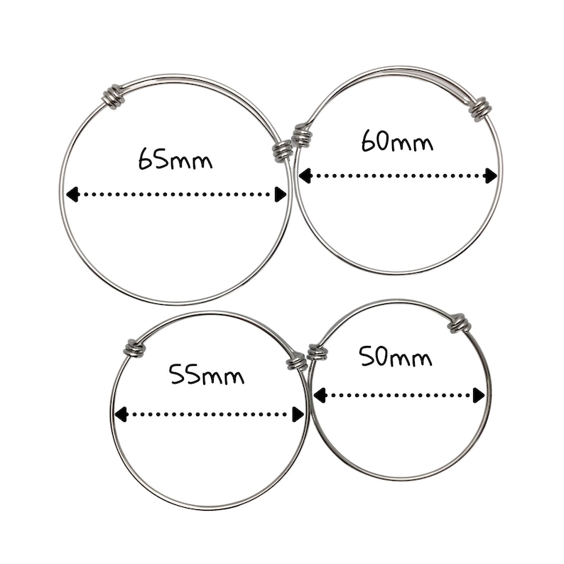 May include: Three silver bangle bracelets with different diameters. The bracelets are 65mm, 60mm, and 55mm in diameter.