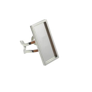 May include: Silver ring setting with a rectangular bezel for a cabochon stone.