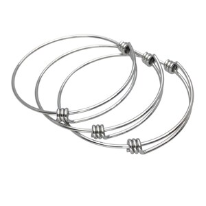 May include: Three silver bangle bracelets with twisted wire closures.