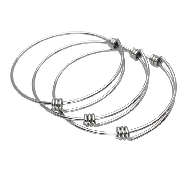 May include: Three silver bangle bracelets with twisted wire closures.