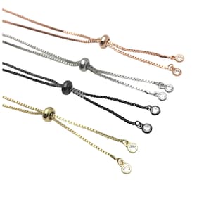 May include: Four adjustable chain bracelets with a sliding bead and two crystal accents. The bracelets are available in gold, silver, rose gold, and black.