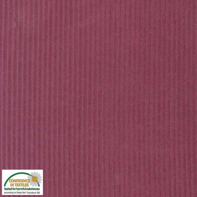 May include: Close-up of a burgundy corduroy fabric with vertical ribbed texture. The fabric has a soft, velvety appearance and a consistent color throughout. The image includes a "Confidence in Textiles" label.