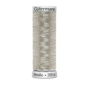 Könnte beinhalten: Eine Spule Gütermann Metallic-Garn in Silber. Die zylindrische Spule hat einen silbernen Boden und Deckel, der Faden ist eng um den Kern gewickelt. Der Text "Gütermann" ist oben aufgedruckt, und "Metallic • 200 m" ist auf der Basis aufgedruckt.
