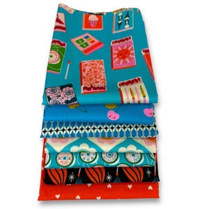 Könnte beinhalten: Ein Stapel bunter Stoffstücke mit verschiedenen Mustern. Die oberste Schicht zeigt einen türkisfarbenen Hintergrund mit Streichholzschachtel-Illustrationen. Weitere Schichten zeigen Muster von Kirschen, geometrischen Formen und floralen Designs. Die untere Schicht ist rot mit weißen Herzen.