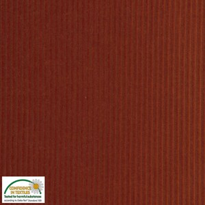 May include: Close-up of a textured, rust-colored corduroy fabric. The fabric has vertical ridges and a soft, velvety appearance. The image includes a "Confidence in Textiles" label.