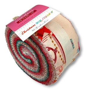 Könnte beinhalten: Eine Stoffrolle mit festlichen Mustern in Rot, Grün und Creme. Die weiße Papierbanderole trägt die Aufschrift Fabric Wonders, 40 Strips / 2.5 inches, 100% Premium Cotton, Christmas in Color und AGFstudio. Die Stoffkanten sind gezackt geschnitten.