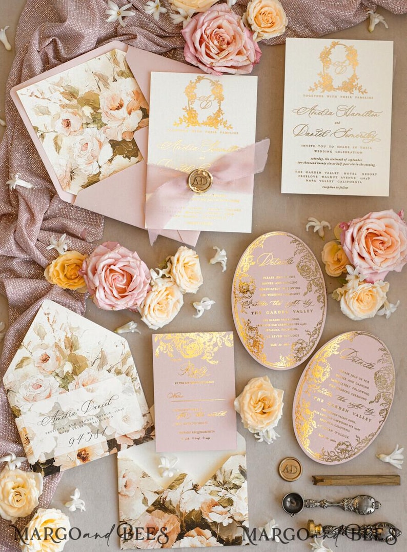 May include: Wedding invitation suite with a floral theme. The invitations are pink and gold with a floral design and the text "Anitia Daniel" and "Anitia Hamilton and Daniel Smith".