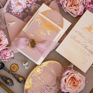 May include: Pink and gold wedding invitation suite with floral details. The invitation features a gold foil design with a floral pattern and the text "Please join us for a dinner and dancing immediately following the wedding ceremony". The details card features a gold foil design with a floral pattern and the text "Details". The RSVP card features a gold foil design with a floral pattern and the text "Please RSVP by the 15th of March".