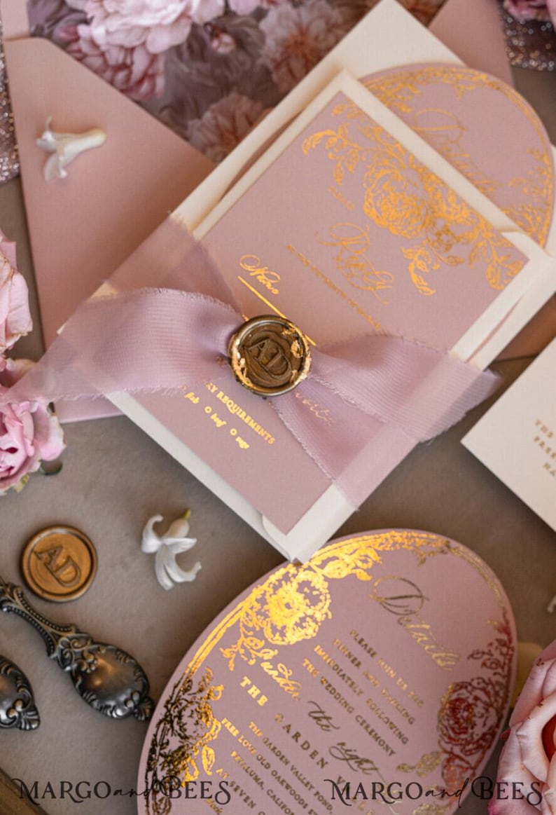 May include: Pink and white wedding invitation with gold foil accents. The invitation features a floral design and the text "The Garden Valley Pond" and "The Garden, the right".