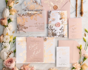 May include: Wedding invitation suite with a blush pink and gold floral design. The invitation features the names "John & Kate Simons" and the text "Save the Date" and "Carte & Michael".