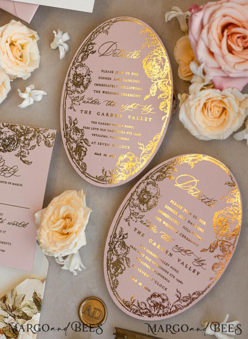 May include: A pink oval wedding invitation with gold foil lettering and floral designs. The invitation reads "Details" and includes the wedding ceremony and reception information. The text reads "Please join us for dinner and dancing immediately following the wedding ceremony under the right sky. The Garden Valley. The Garden Valley Pond, Free Love Old Oakwoods Sta. 1939 Petaluma, California. At Seven O'Clock. Black Tie."