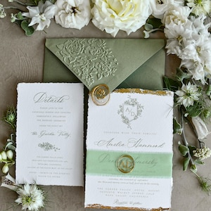 May include: A wedding invitation suite featuring a sage green envelope with a floral embossed flap, a white details card, and a main invitation with deckled edges, gold leaf accents, a green ribbon band, and gold wax seals with floral motifs.