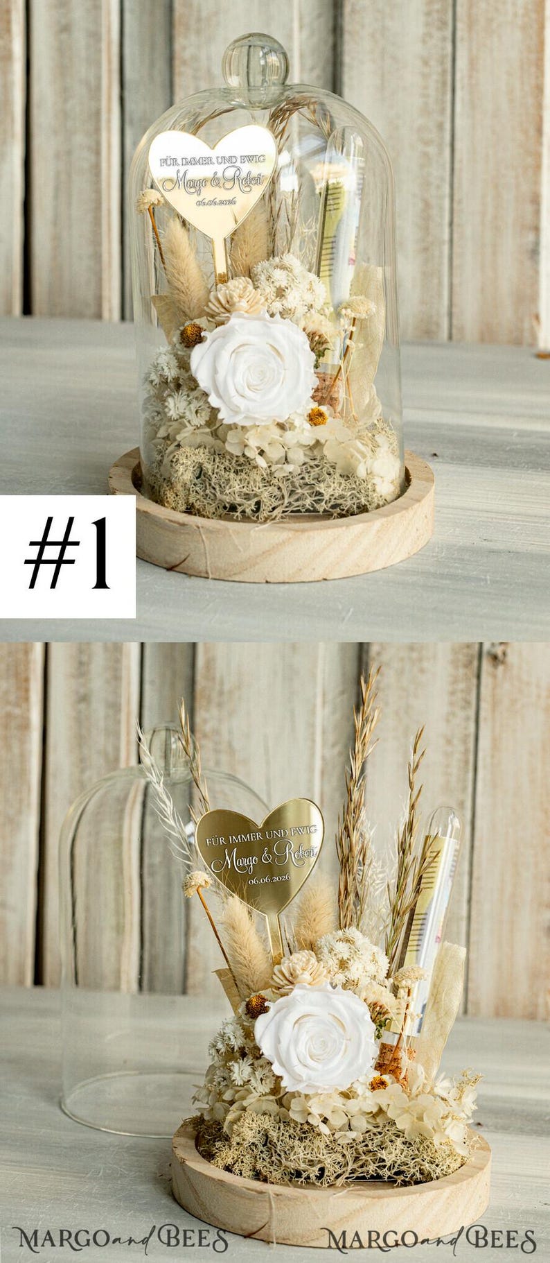 May include: A glass dome with a wooden base contains dried flowers and a gold heart-shaped plaque with the text "F&Uuml;R IMMER UND EWIG Margo & Reken 06.06.2026".