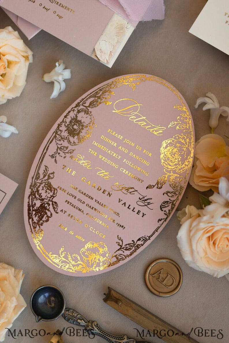 May include: A pink oval wedding invitation with gold foil detailing. The invitation features a floral design and the text "Details", "Please join us for dinner and dancing immediately following the wedding ceremony", "Under the right sky", "The Garden Valley", "The Garden Valley Fund, 15987 Love Old Oakwards St. Petaluma, California", "At Seven O'Clock", "Black tie attire".