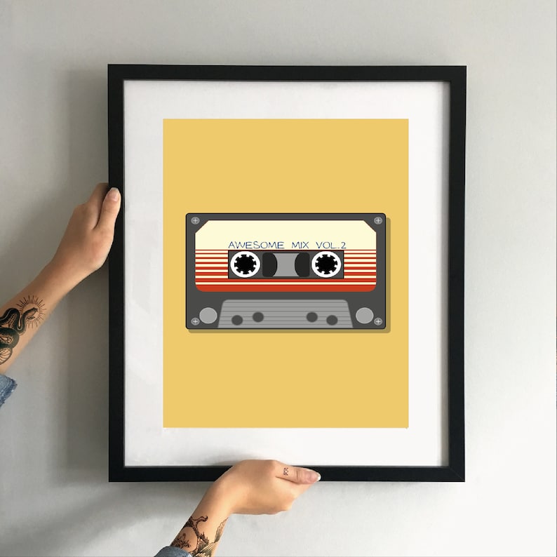 May include: A framed print of a cassette tape with the text "Awesome Mix Vol. 2" on a yellow background.