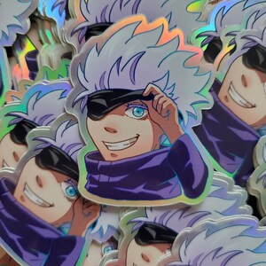 May include: A stack of holographic stickers featuring a cartoon character with white hair, a purple shirt, and an eye patch. The character is smiling and holding an eye patch over one eye.