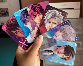 May include: A set of six illustrated cards featuring anime-style characters with colorful backgrounds. The cards are printed on glossy paper and have rounded corners.