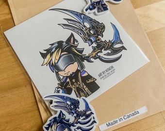 May include: A collection of stickers and a print featuring a cartoon character with a blue and black color scheme. The print has the text "ART BY KITACHI" and the stickers have the text "Made in Canada". The stickers and print are on a brown paper.