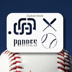 May include: A white stencil with the words "PADRES" and the team logo, crossed baseball bats, and a baseball. The stencil is on top of a baseball. The text "Daydream Stencils" is at the top of the stencil.