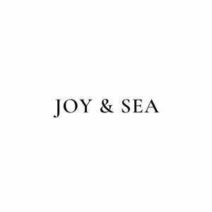 May include: A simple logo design with the text "JOY & SEA" in black font on a white background.
