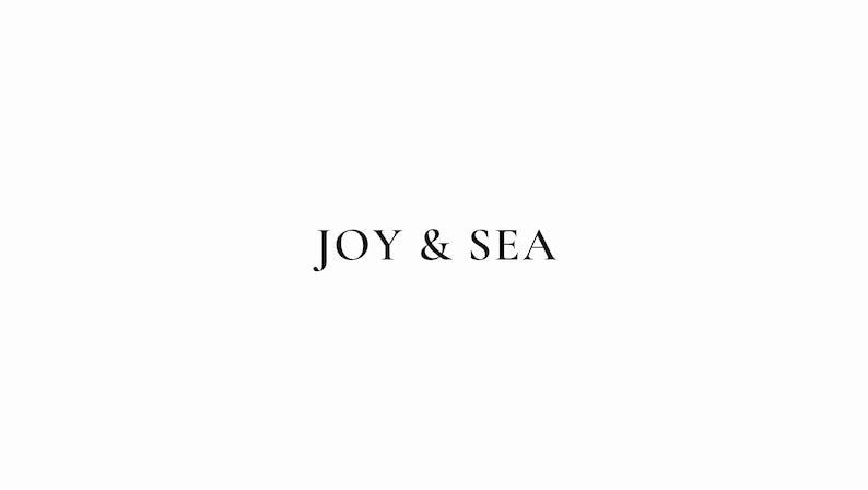 May include: A simple logo design with the text "JOY & SEA" in black font on a white background.