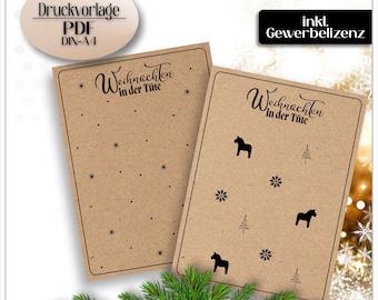 Puede incluir: Dos tarjetas de papel kraft con el texto "Weihnachten in der Tüte" e iconos negros de copos de nieve, caballos y árboles de Navidad. Las tarjetas tienen el texto "Druckvorlage PDF DIN-A4" e "inkl. Gewerbelizenz".