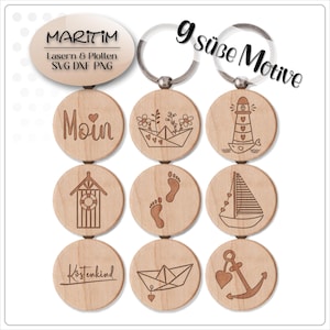 May include: Nine wooden keychains with nautical designs, including a lighthouse, sailboat, and anchor. Each keychain is round and made of light-colored wood. The keychains have a metal ring at the top. The word "Moin" is engraved on one keychain.