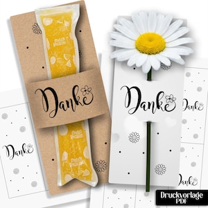 May include: A printable PDF template featuring the word Danke in black script with flower icons. One version is on brown cardstock holding a yellow ice pop, and another is on white cardstock with a white daisy. Includes small dot patterns.