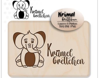 Puede incluir: Un letrero de madera con una ilustración de elefante marrón y el texto "Krümel brettchen" en una fuente cursiva. El letrero también incluye el texto "Lasern & Plotten SVG DXF PNG" en una fuente más pequeña.