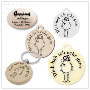 May include: A collection of wooden and light-colored keychains and tags. Each item features a cartoon bird design with the German text "Dich hab ich echt gern" (I really like you). One keychain is attached to a silver ring.