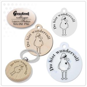 May include: A collection of wooden and acrylic keychains and gift tags. The keychains and tags feature a cartoon seagull design with the phrase "Du bist wundervoll" and the text "Geschenk anhänger".