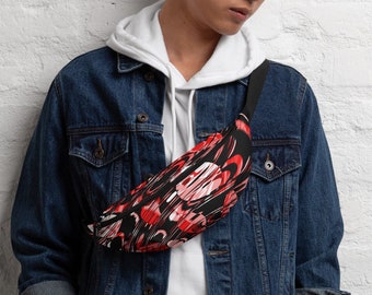 May include: A person wearing a denim jacket and white hoodie with a black and red fanny pack with a graphic print. The fanny pack is worn across the body.