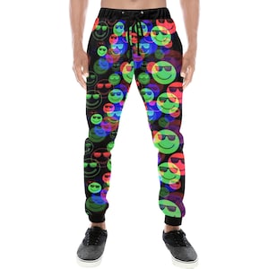 May include: Black sweatpants with a colorful pattern of smiling faces wearing sunglasses. The faces are in shades of green, red, blue, and yellow.