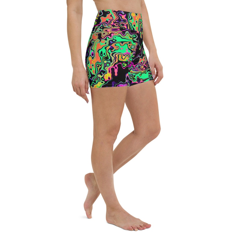 May include: Black athletic shorts with a colorful abstract print of swirling neon green, pink, orange, and yellow shapes. The shorts have a high waist and a fitted silhouette.