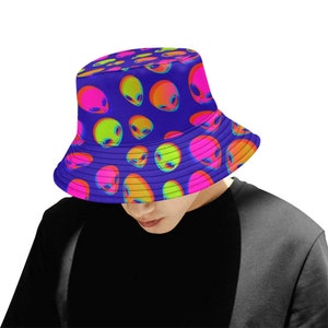 May include: A blue bucket hat with a pattern of neon green, pink, and orange alien faces.