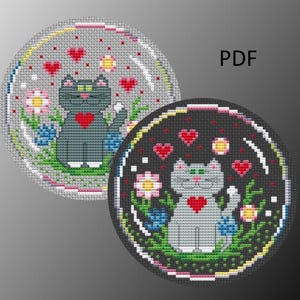May include: Two cross-stitch patterns of a gray cat with a red heart in a circle of flowers and hearts. The patterns are on a white and black background. PDF.