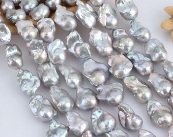 May include: A strand of baroque freshwater pearls in a silvery grey colour. The pearls are irregular in shape and have a high lustre.