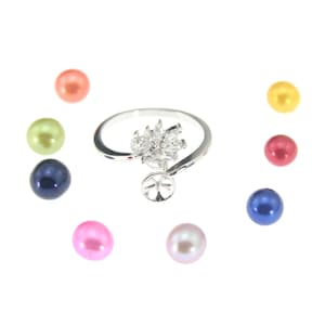 May include: A silver ring with a clear crystal design and a pearl setting. The ring is shown with a variety of coloured pearls, including pink, green, blue, black, and white.