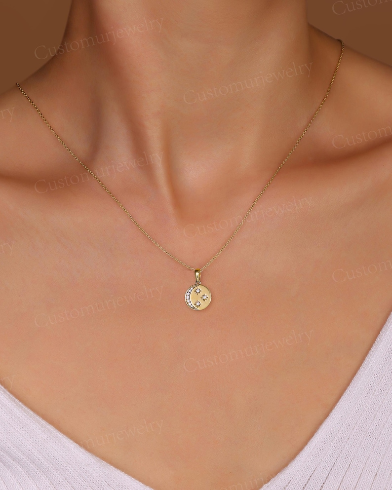 A close-up view of a woman's neck and chest area wearing a gold necklace with a small pendant.