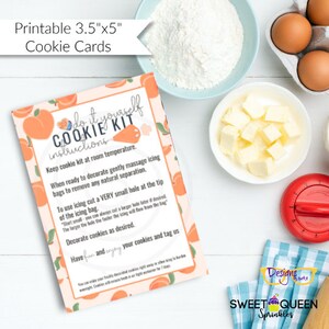 May include: A printable 3.5" x 5" cookie card with instructions for decorating cookies. The card features peach illustrations and text, with ingredients like flour, eggs, and butter in the background. The card reads "Do it yourself Cookie Kit".
