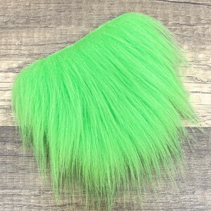 May include: A bright green fur patch for fly tying. The fur is soft and fluffy, perfect for creating realistic fly patterns.