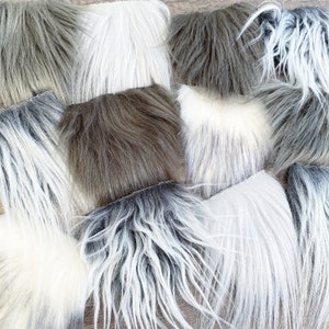 May include: Assortment of faux fur fabric swatches in various colors and textures, including white, gray, and brown.