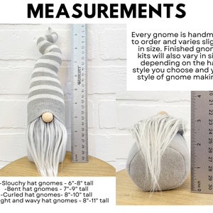 Może przedstawiać: Ręcznie robiony gnom z szaro-białą czapką w paski, drewnianym nosem i białą brodą. Gnom ma około 15-20 cm wysokości. Obraz zawiera tekst "WYMIARY" oraz szczeg&oacute;ły dotyczące rozmiaru gnoma.