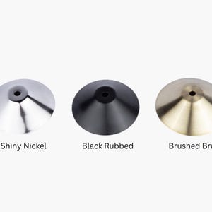 May include: Three metal lampshades in different finishes: shiny nickel, black rubbed, and brushed brass.