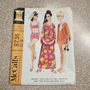 May include: Vintage McCall's sewing pattern 8736 featuring illustrations of women's clothing. The pattern includes a two-piece bathing suit and djellaba in two lengths. The cover is orange and white with the text "McCall's Printed Pattern".