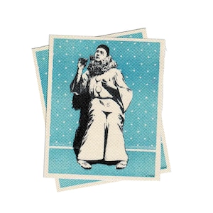 May include: A black and white image of a clown wearing a white costume with a blue background. The background has a white polka dot pattern.