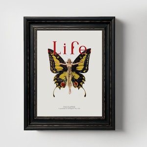 May include: A vintage magazine cover featuring a woman with wings, resembling a butterfly, against a white background. The magazine title "Life" is printed in red letters above the woman. The text "The Flapper" is printed below the woman.